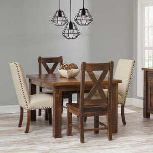 Rustic leg dining table in a warm brown finish with X back side chairs and cream nailhead upholstered chairs