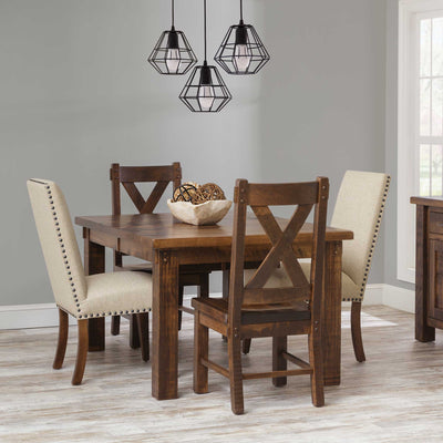 Rustic leg dining table in a warm brown finish with X back side chairs and cream nailhead upholstered chairs