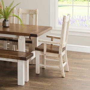 Rustic dining chair with a distressed white painted frame and dark plank seat, shown with a matching farmhouse table and bench