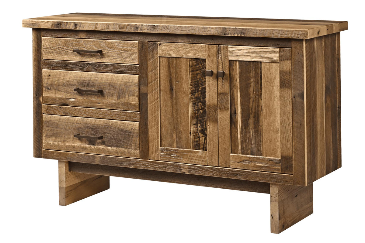 A rustic wooden sideboard cabinet with three drawers on the left, two paneled doors in the center, and block legs, shown on a plain white background.
