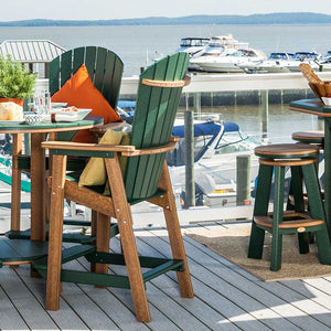Green and cedar Adirondack bar height chairs with fan backs at a tall table on a marina deck