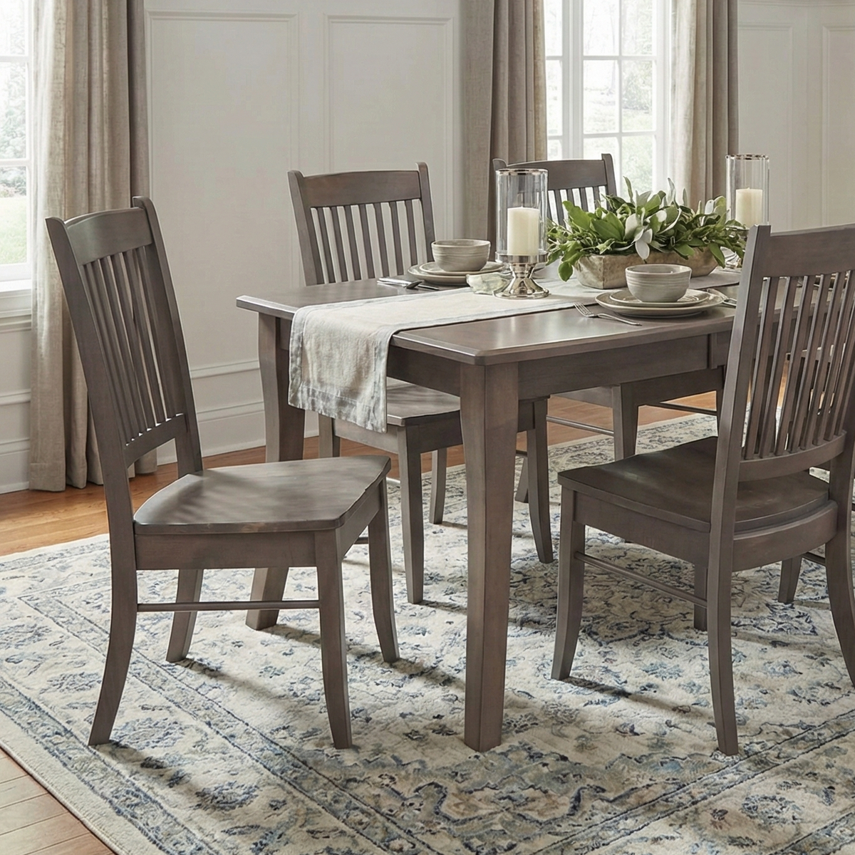 Dining room with wooden table and chairs on a patterned rug