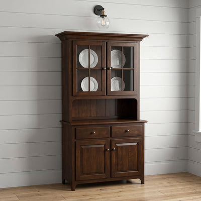 Cherry two-door hutch with mullion glass doors, open plate shelf, two drawers and paneled base cabinet