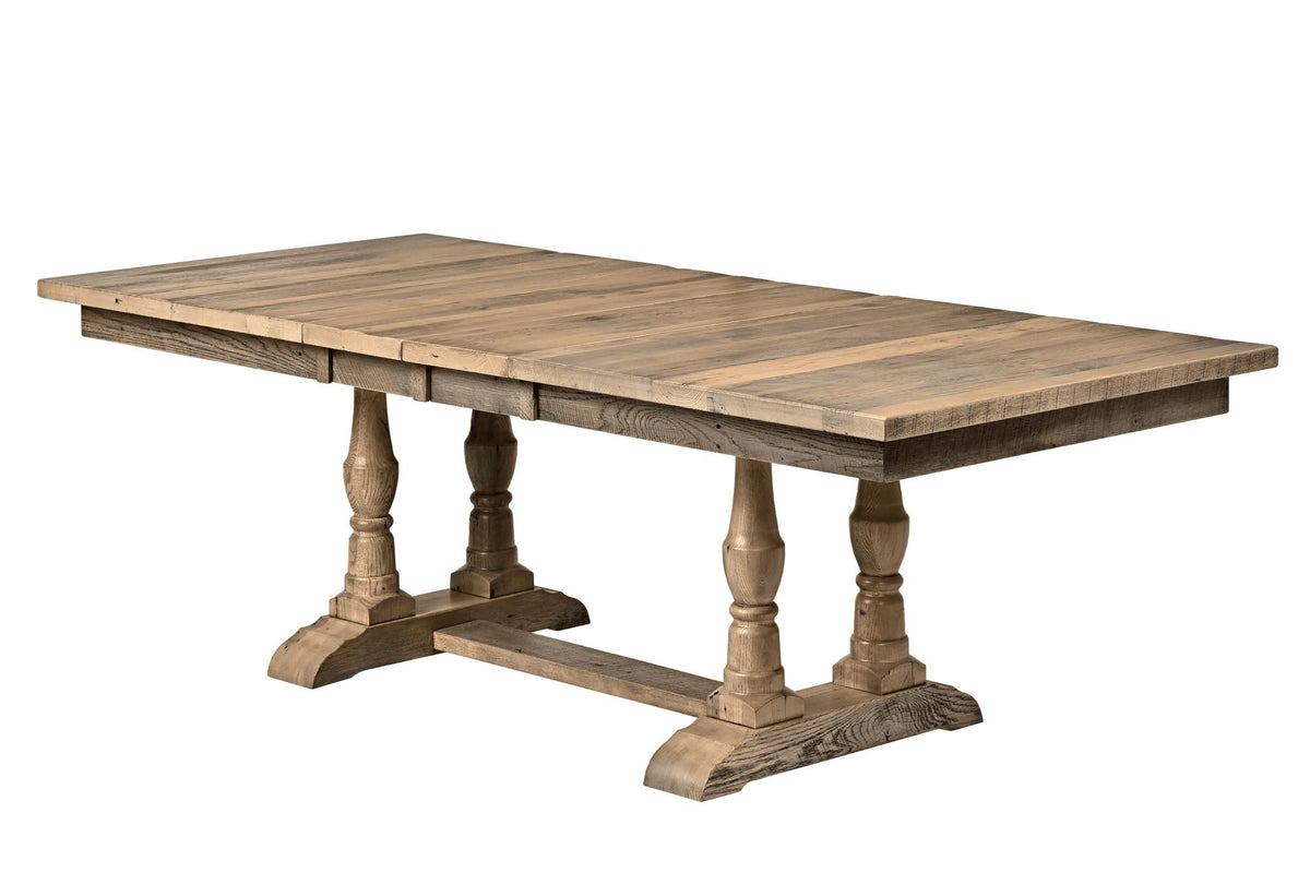 A rustic farmhouse-style wooden dining table with a slatted rectangular top and turned trestle legs, shown on a plain white background.