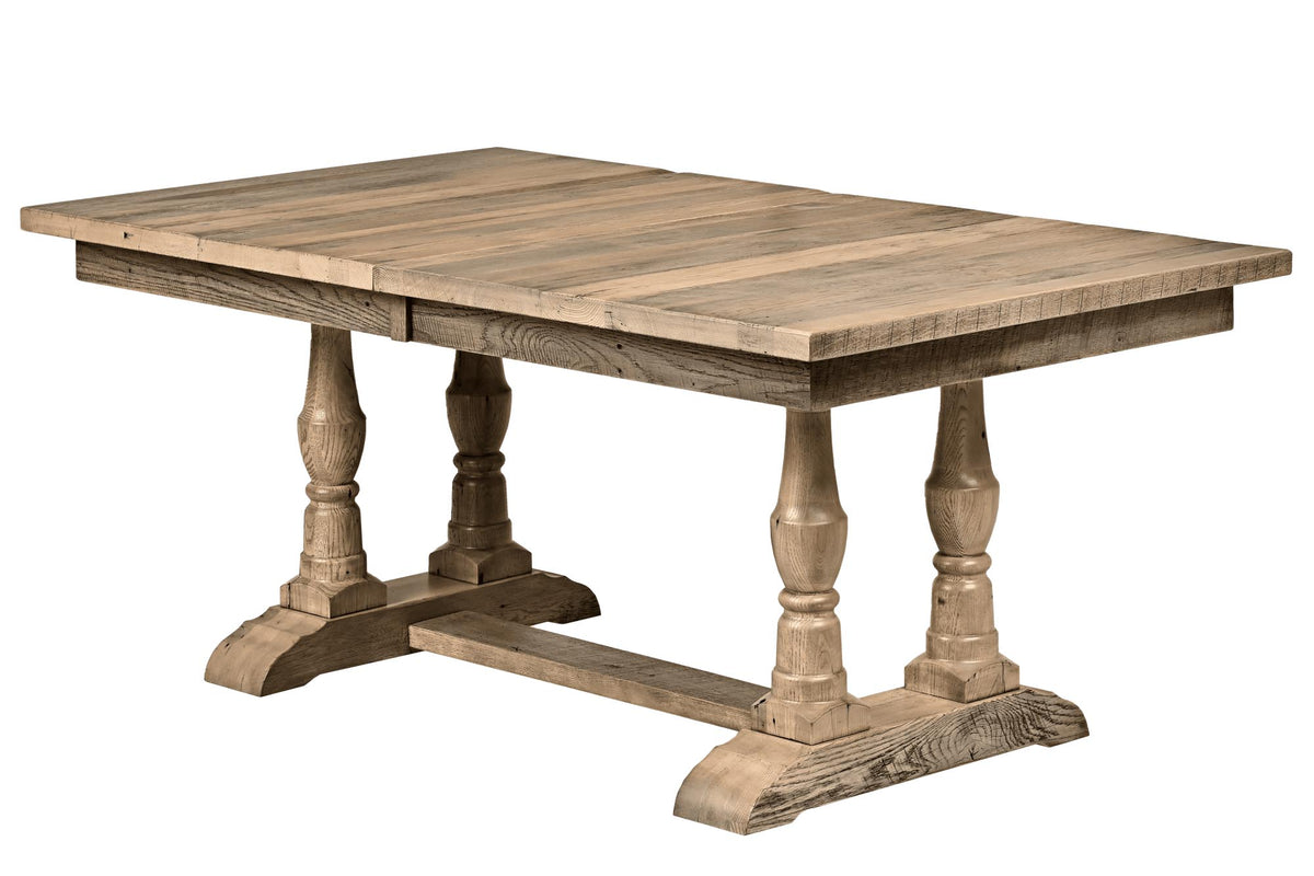 A rustic wooden dining table with a rectangular plank top, turned trestle legs, and a stretcher base, shown on a plain white background.