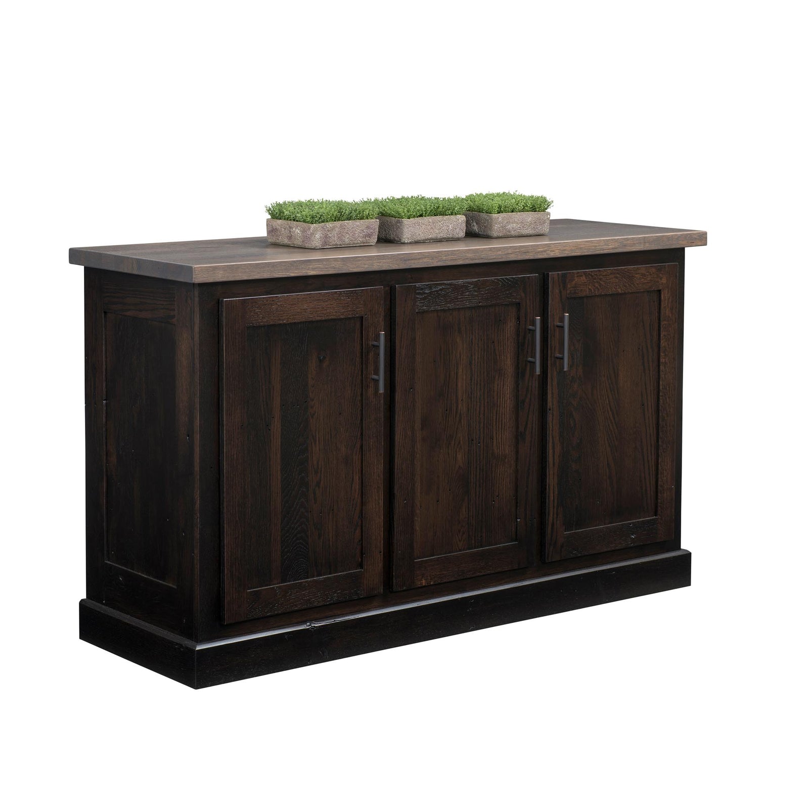 A dark brown wooden sideboard or buffet cabinet with three paneled doors and a rustic gray-brown top surface, shown on a plain white background with three small potted green plants on top.