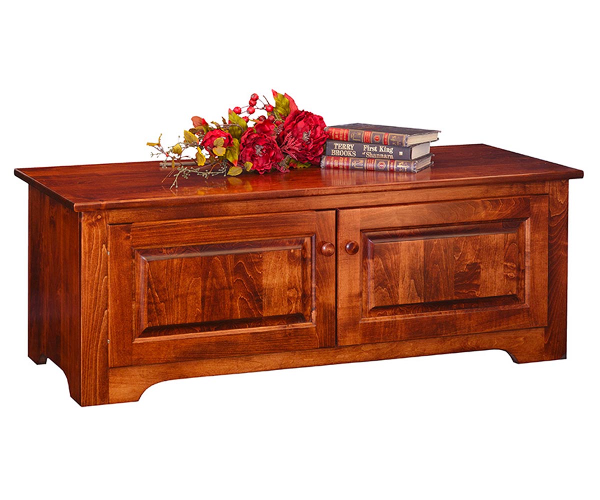 Wooden chest with floral arrangement and books on a white background
