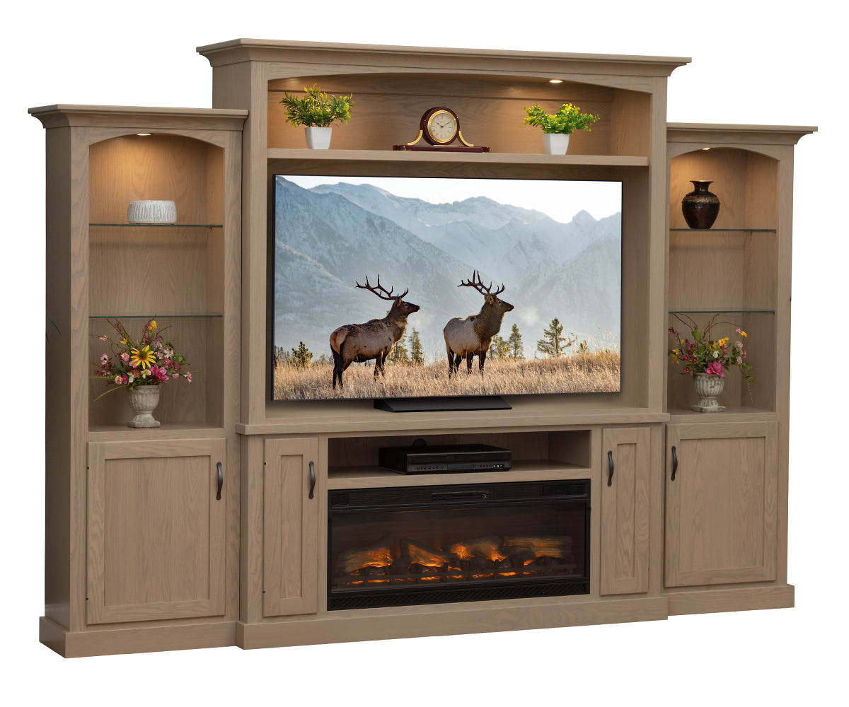 Wooden entertainment center with TV displaying elk, shelves with decor, and fireplace.
