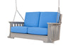 Gray poly Mission porch swing for two with blue cushions hanging from chains on a covered porch