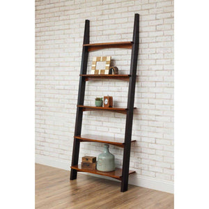 Leaning wall ladder bookcase with black side rails and five curved cherry shelves against white brick