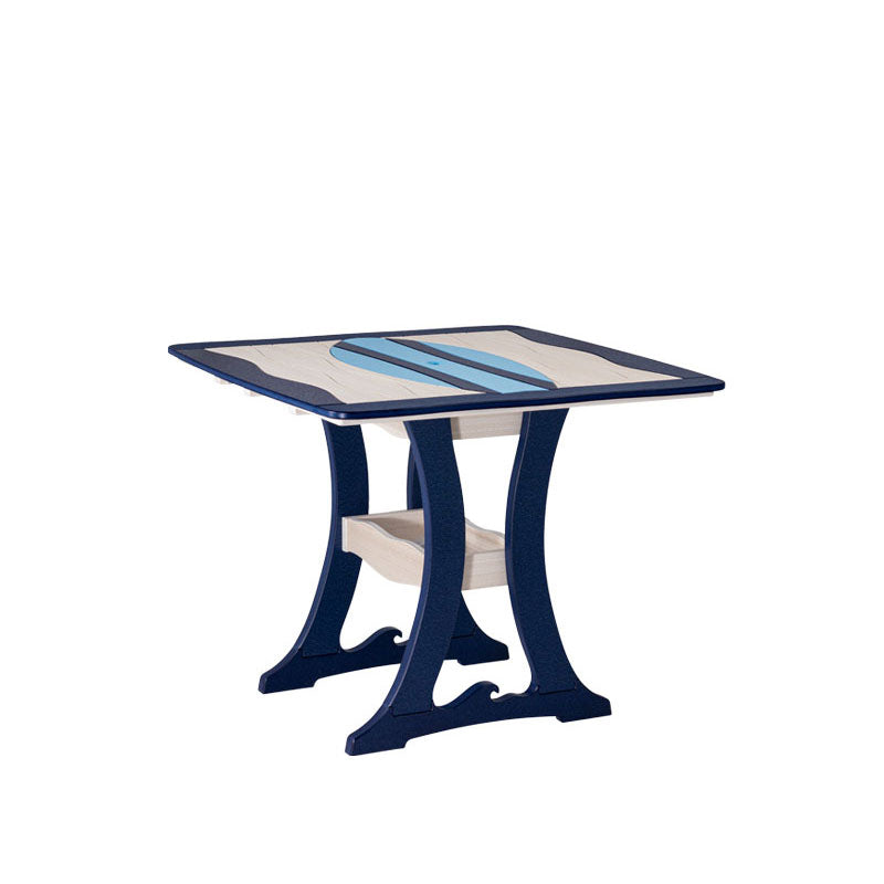 Angled view of a navy and sand poly dining table with light blue surfboard inlay, curved legs and shelf on white
