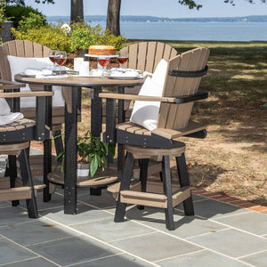 Weathered wood and black swivel Adirondack bar chairs at a round poly pub table set on a waterfront patio