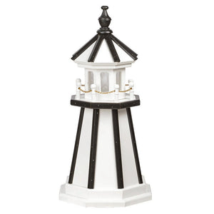 White poly lighthouse with black vertical corner stripes, black roof and finial, white railing posts and gold chain