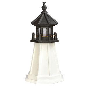 Two foot poly garden lighthouse in white with a black hexagonal lantern room, railing with chain and finial top, on white