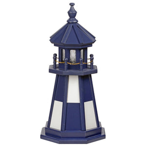 Navy blue wooden lawn lighthouse with white panel windows, blue lantern room, gold chain railing and finial top
