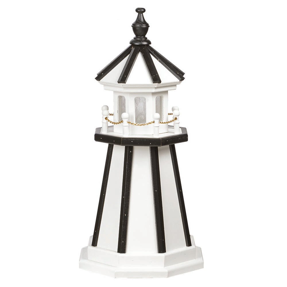 White wooden lighthouse with black corner stripes and roof, white railing posts with gold chain and black finial