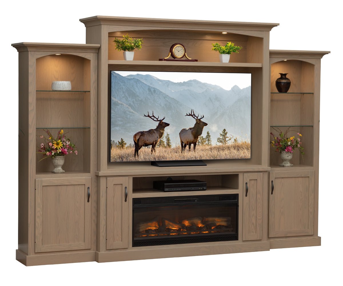 Wooden entertainment center with TV displaying elk, shelves with decor, and fireplace.