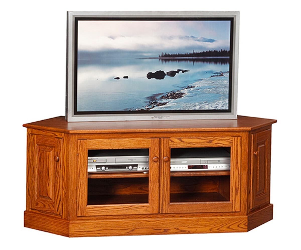 Golden oak four door corner TV console with two glass center doors, raised panel end doors and a molded base on white
