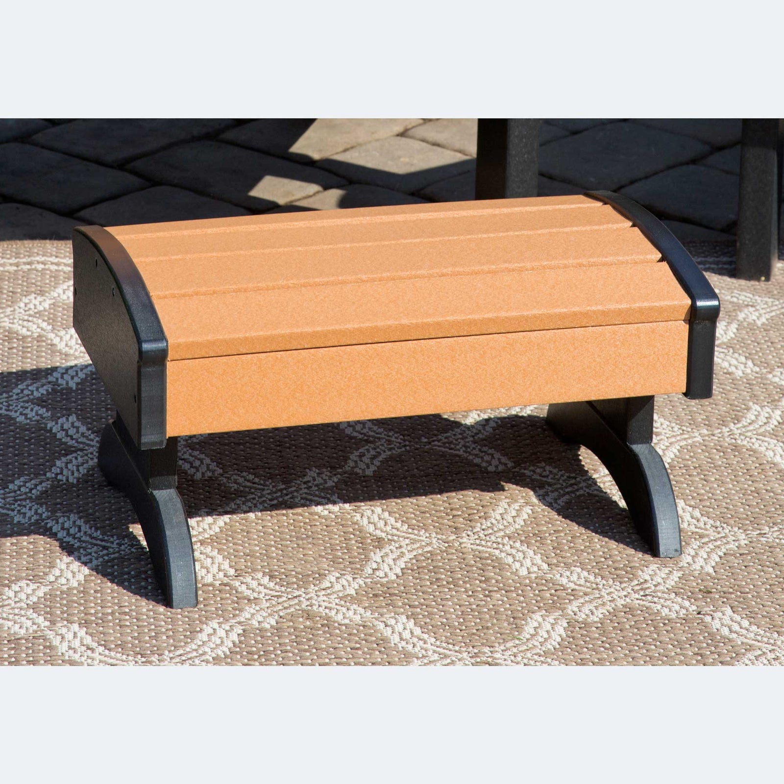 Cherrywood red poly Adirondack chairs with cup holders, matching footstools and a shared settee table on a patio