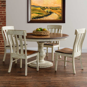 Round pedestal dining table with a brown stained top and antique white turned base, with four matching slat back chairs