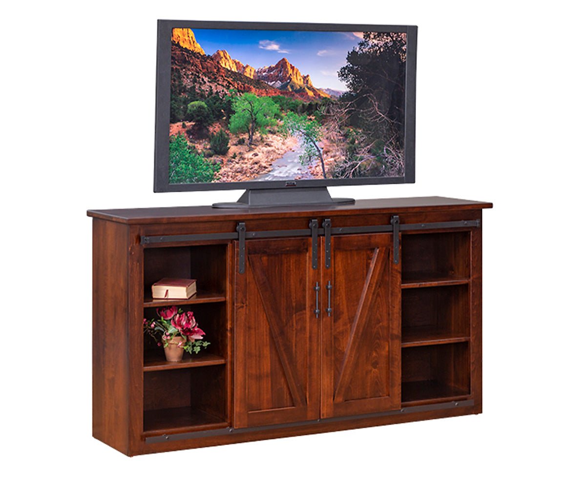 Barn door TV console in medium brown with two sliding V panel doors, open side shelves and black strap hardware