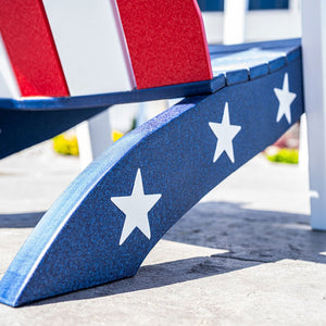 Close-up of the navy blue Adirondack chair leg with three white stars beside the red and white striped back