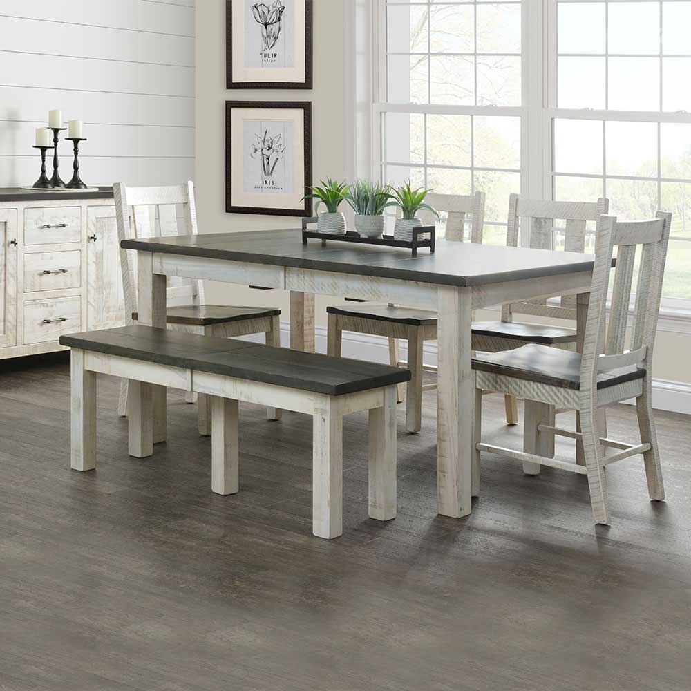 Two-tone farmhouse dining table with bench and four chairs in a shiplap dining room with framed botanical prints