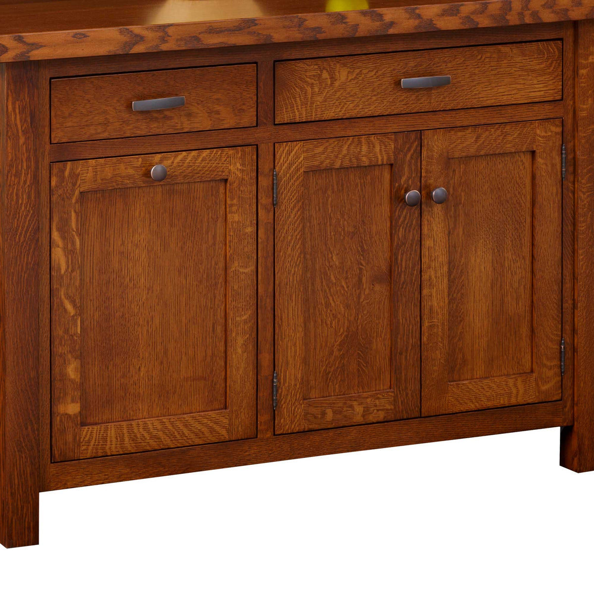 Oak island cabinet detail showing tiger-grain door panels, bar pull drawers and a thick butcher block top edge