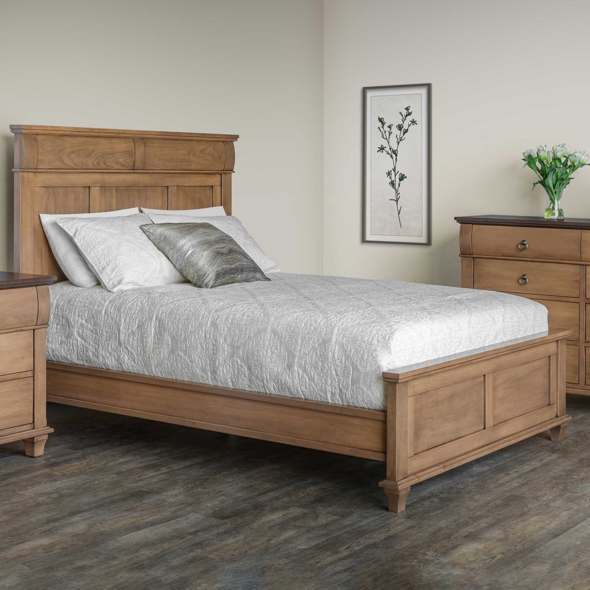 Light almond panel bed with a tall paneled headboard styled with white bedding beside a nightstand and chest