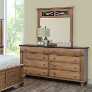 Light almond triple dresser with dark top and a lattice topped mirror styled with lamps in a sunlit bedroom