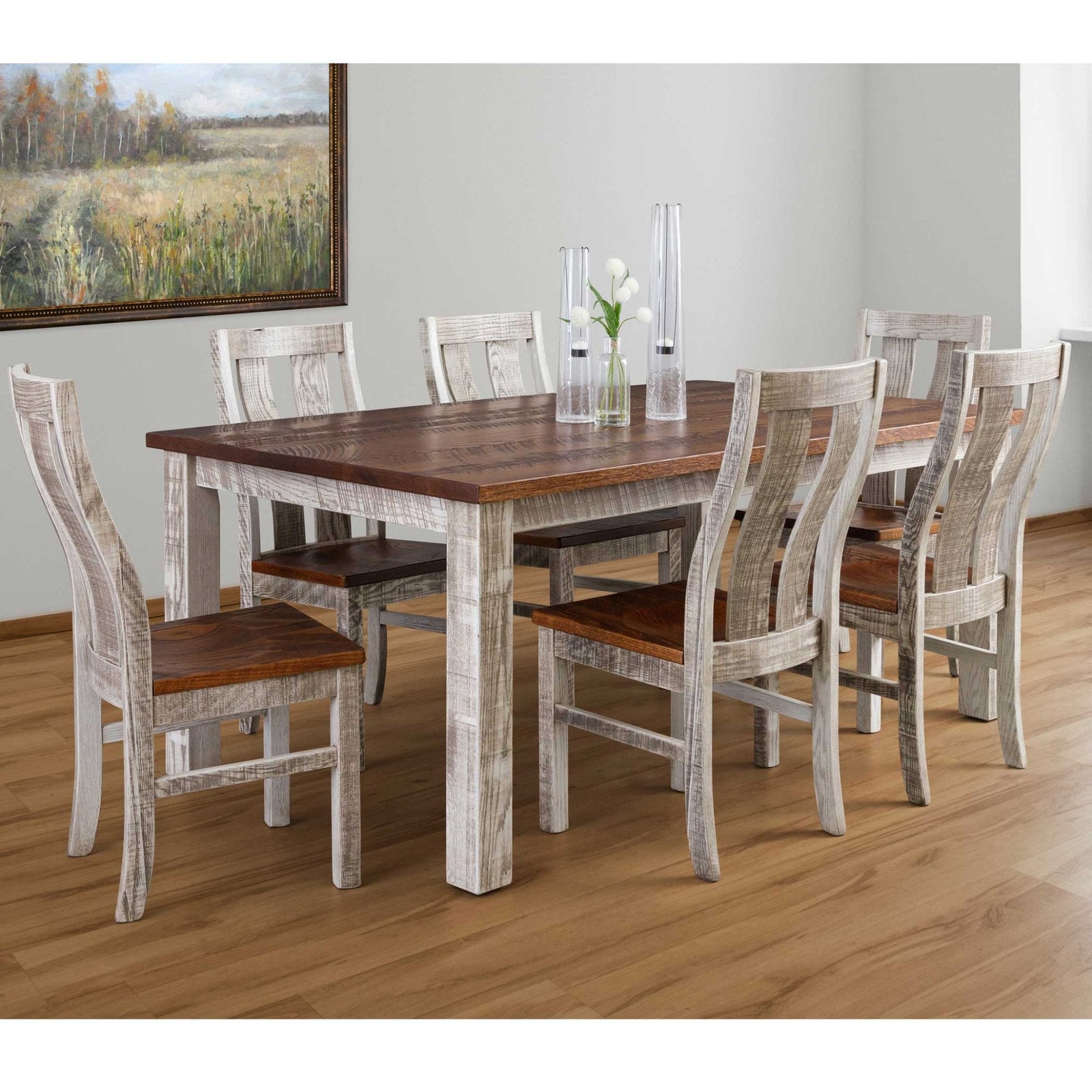 Brown weathered farm table with six ladder back chairs and a small planter centerpiece in a sunlit room