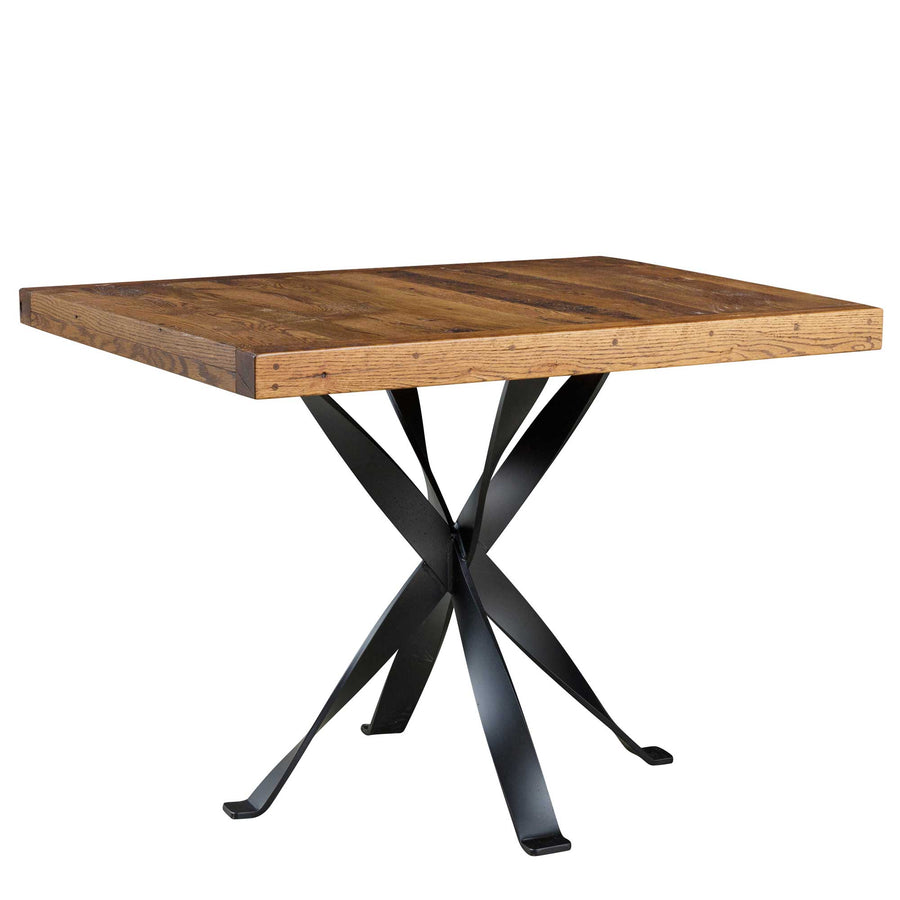 Square reclaimed wood dining table with a plank top on a sculptural black iron crossed spider base