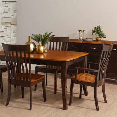 Two-tone dining chairs with dark espresso frames and natural oak seats at a table with a golden oak top