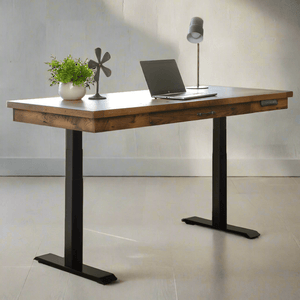 Reclaimed barnwood standing desk with a plank top, single drawer and black electric lift legs in a plain room