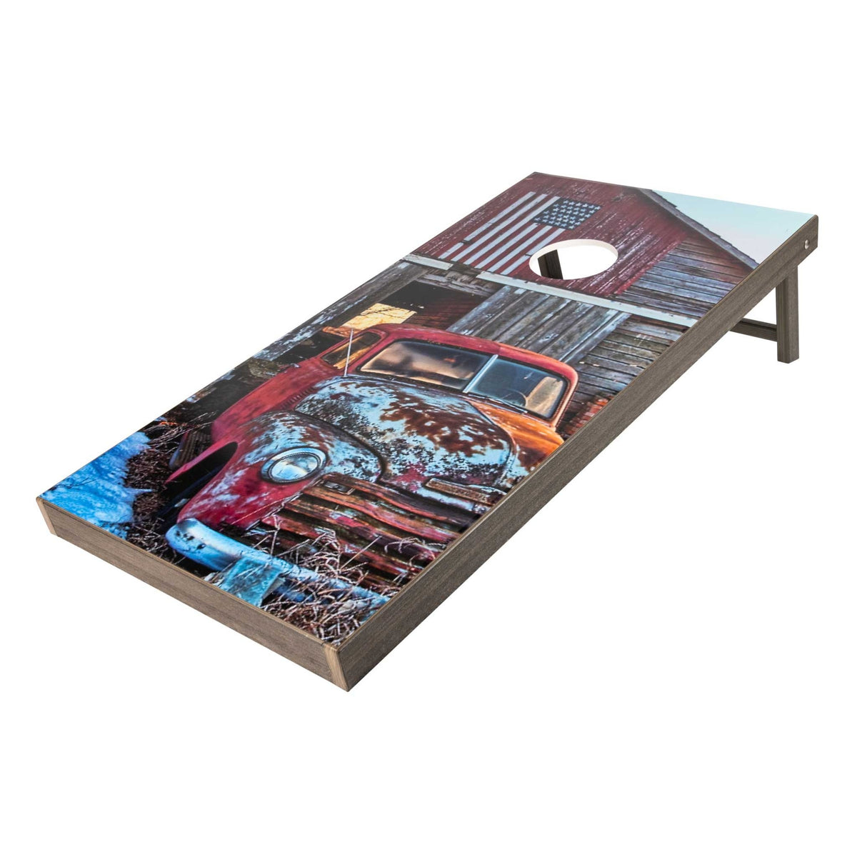 Cornhole board featuring a vintage red pickup truck and flag painted barn on a weathered gray frame