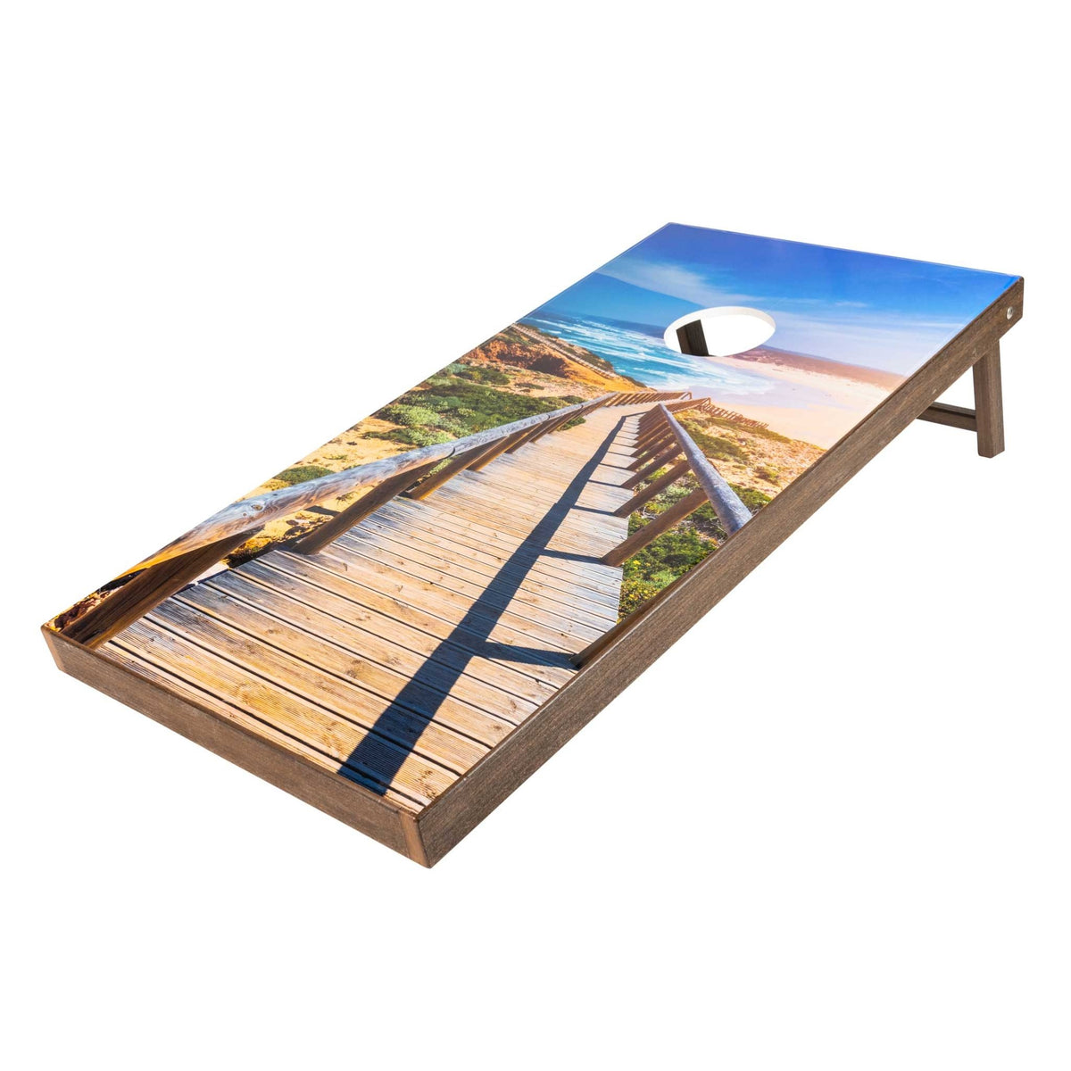 Beach boardwalk print cornhole board with dune path and ocean view on a brown wood frame