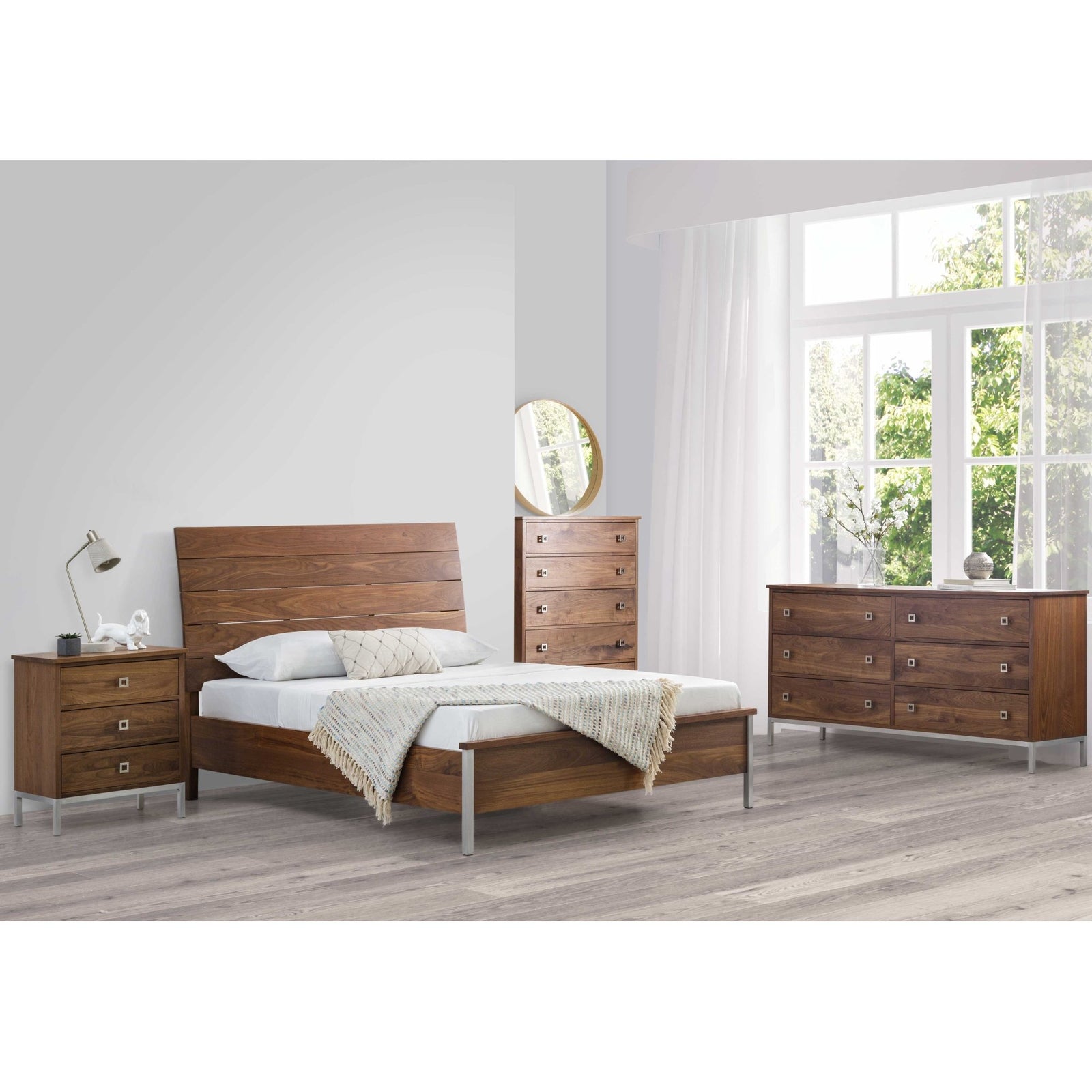 Modern walnut bedroom suite with a plank headboard bed, chest of drawers, nightstand and round mirror