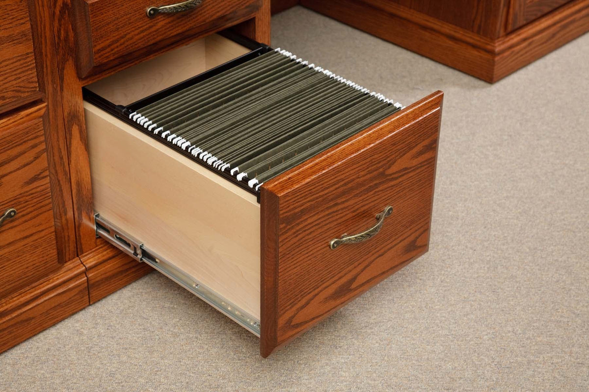 Deep oak file drawer opened to reveal a full set of green hanging folders on metal glides