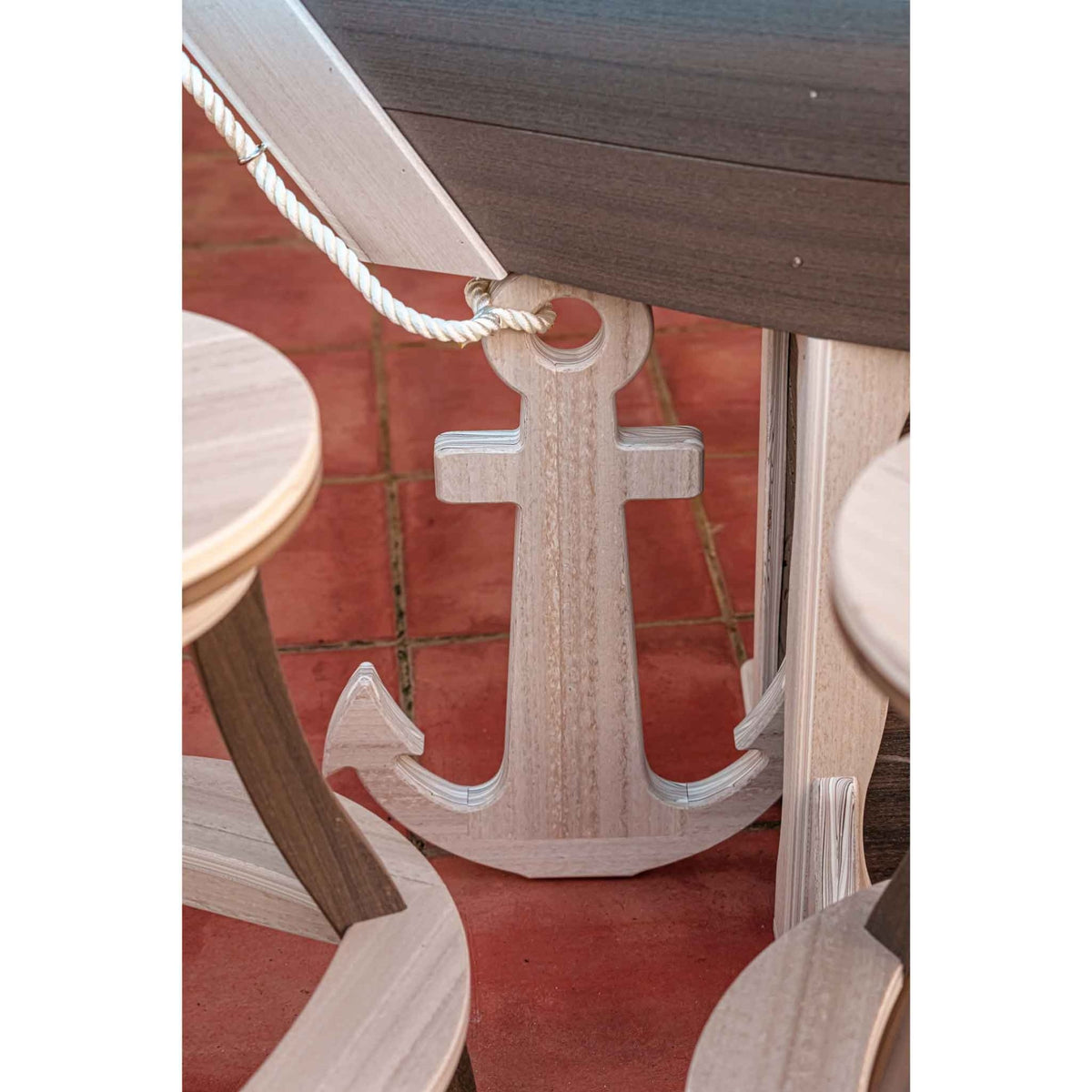 Detail of the white anchor and rope accent on the front of the boat shaped outdoor bar