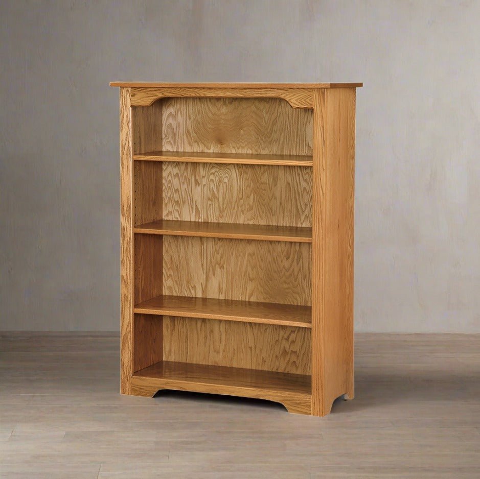 Oak 48 inch bookcase with three adjustable shelves and a shaped top rail, shown in a plaster-walled room