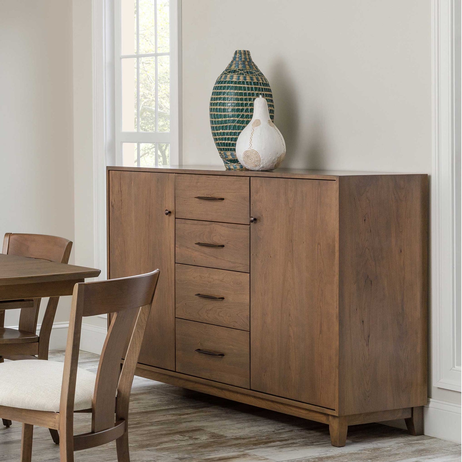 Mid century modern dining sideboard in walnut brown with two doors, four center drawers and angled legs