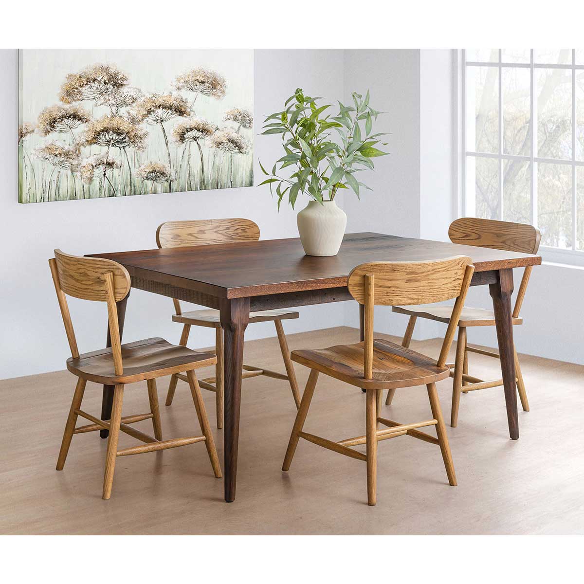 Rectangular reclaimed wood dining table with a warm walnut toned top and tapered round mid century style legs