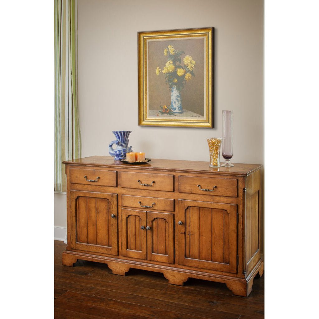 Oak Provence storage buffet with four drawers, three paneled doors, brass bail pulls and a bracket base