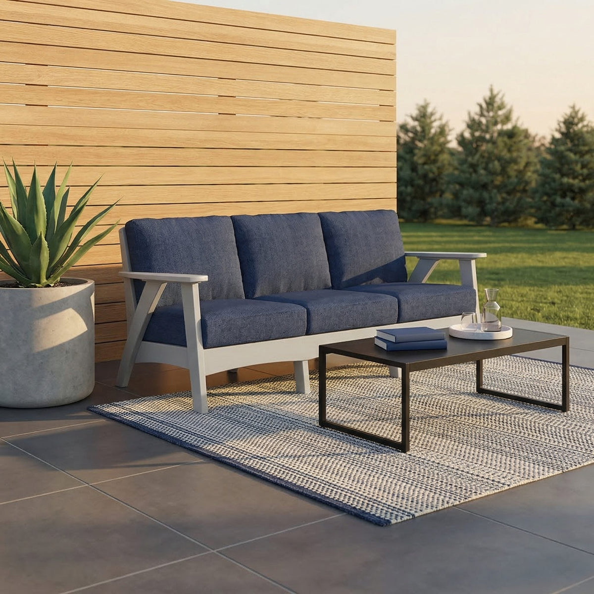 Fernandina poly cushion sofa, light gray with spectrum indigo cushions, patio with coffee table - lifestyle (other pieces sold separately)