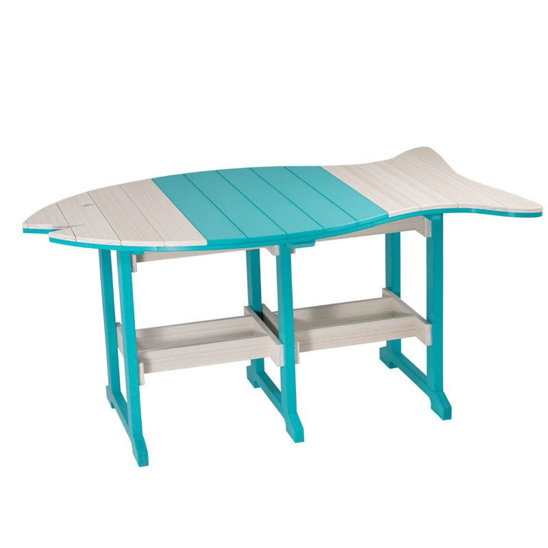 Large fish shaped poly dining table in navy and driftwood set with white plates and four matching chairs on a dock
