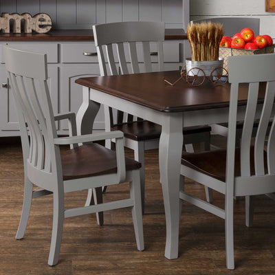 Gray dining chairs with lumbar slat backs and dark brown seats at a gray table with walnut top