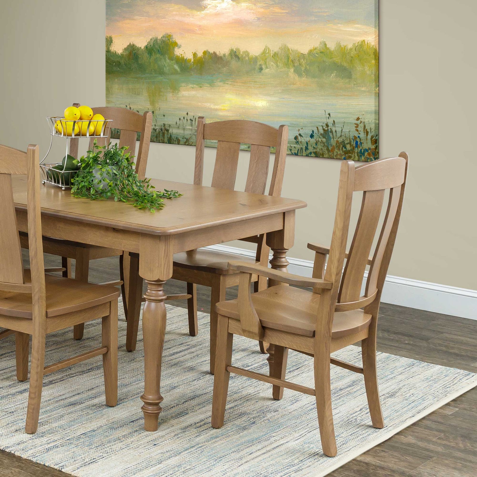Light stained dining set with a turned leg table, arm chair and side chairs with shaped back slats