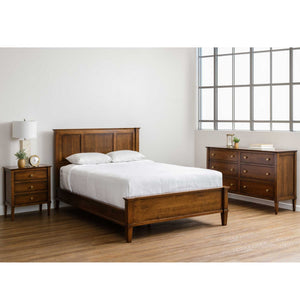 Cherry bedroom set with a paneled headboard bed, three drawer nightstand and six drawer dresser by a tall window