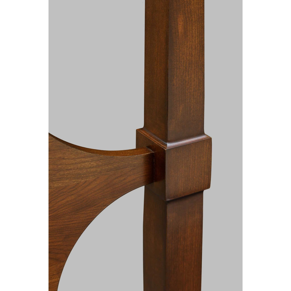 Detail of a cherry poster bed post and the curved headboard connection with a stepped block collar