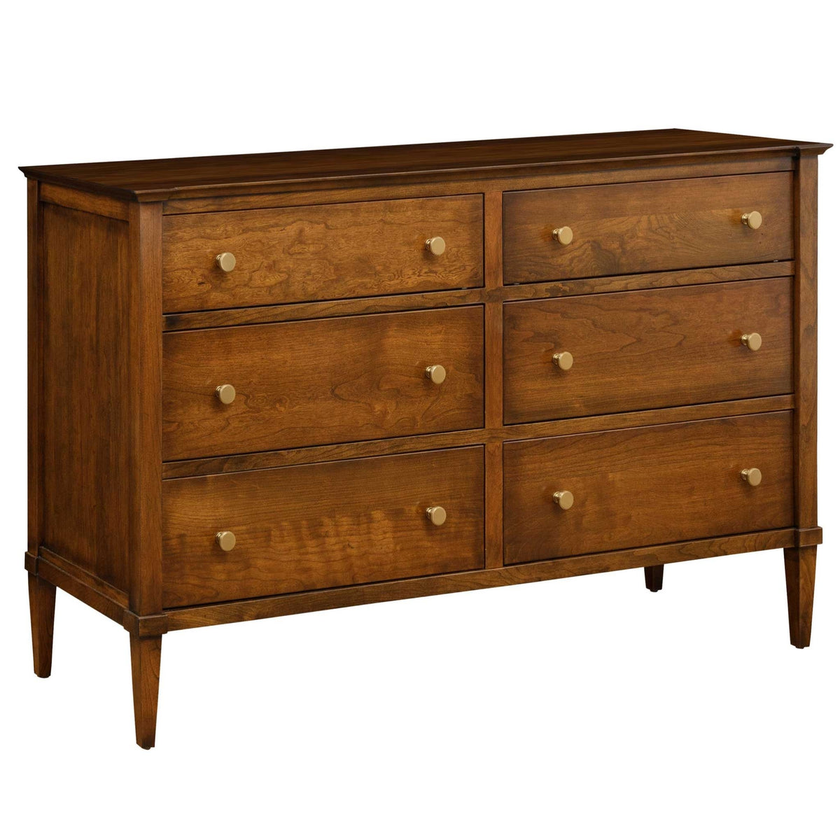 Angled view of the cherry double dresser with six drawers in two columns, brass knobs, paneled sides and tapered legs